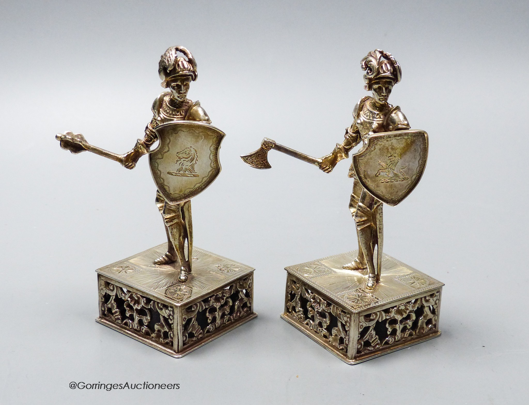 A pair of late 19th/early 20th century Hanau? white metal miniature model knights, on pieced square bases, height 11cm, 10.5oz.